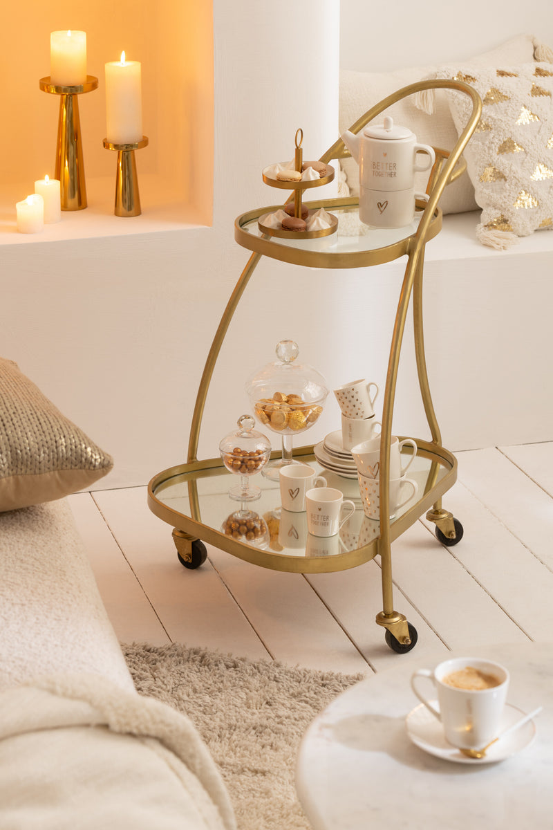 Elegant triangular service trolley made of metal in mirror gold