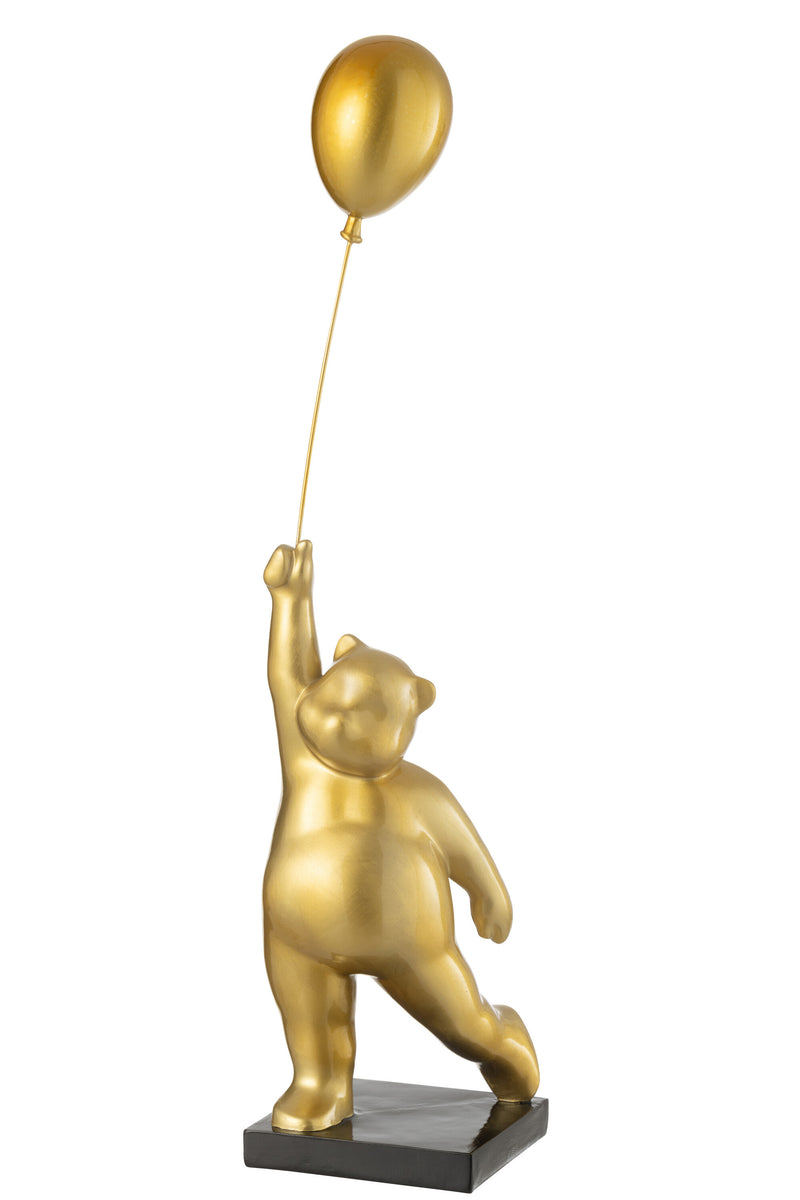 Bear on ball made of shiny polyresin in gold