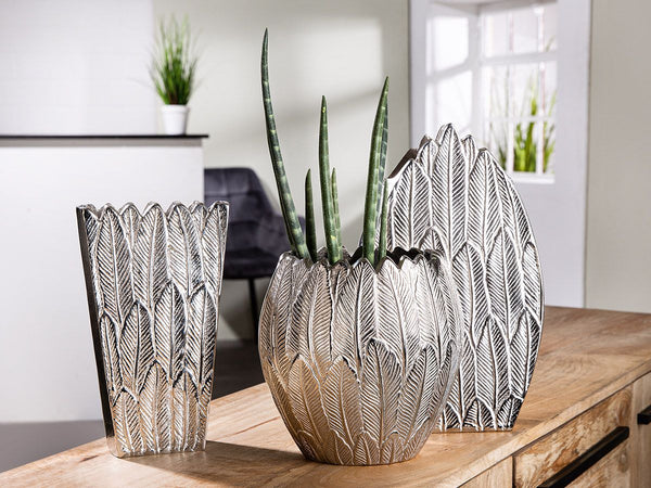 Feather Trio A collection of handmade silver colored aluminum vases