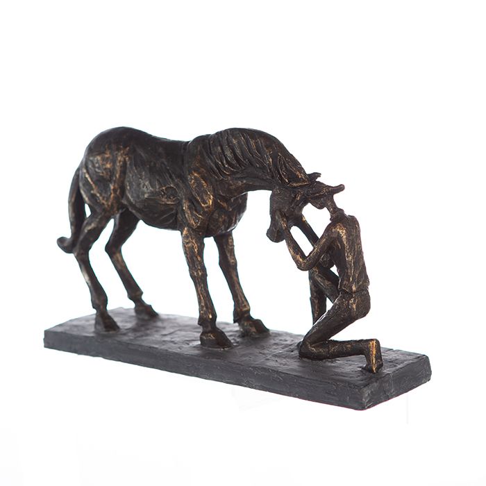 Sculpture Comprehension - Bronze-colored depiction of a horse with a rider on a gray base including a saying pendant
