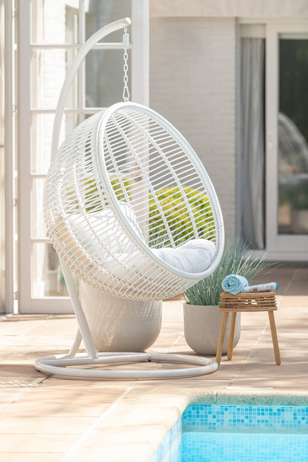 Round hammock chair made of steel and wicker in white: relaxation and coziness outdoors