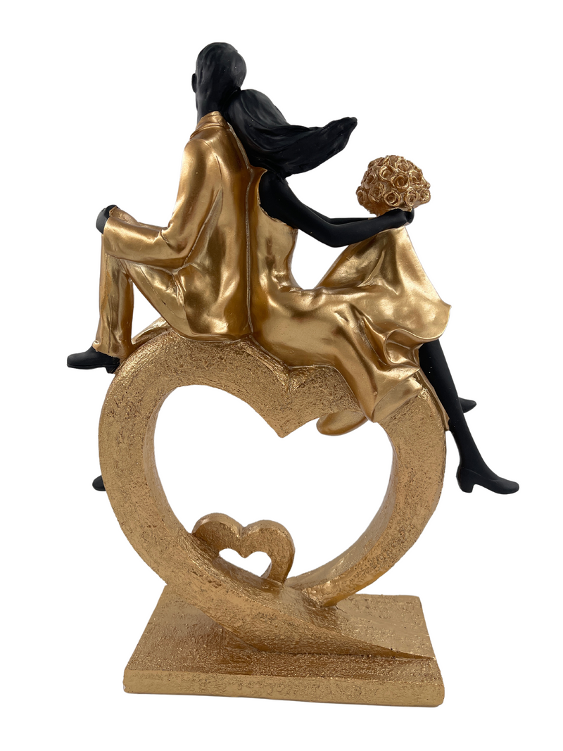 Elegant sculpture of a seated couple in heart shape, black and gold