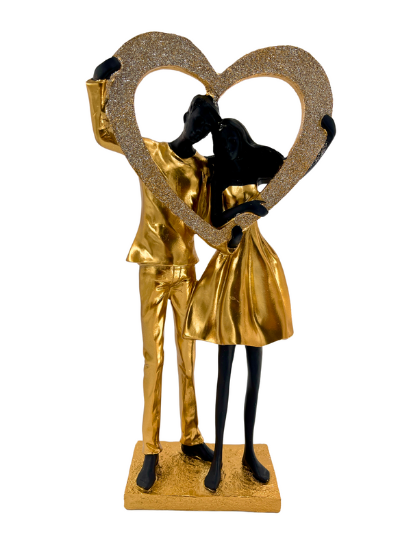 Elegant sculpture of a couple in black and gold with heart shiny