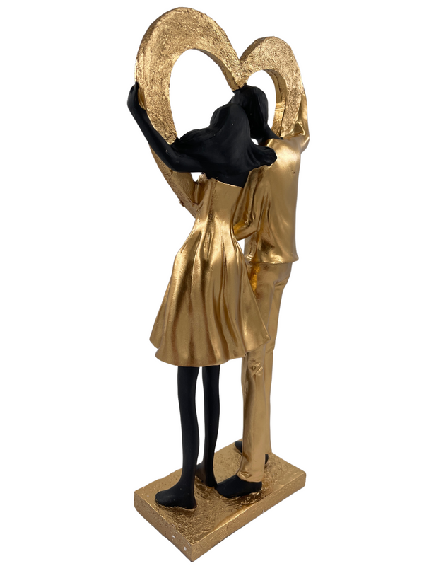 Elegant sculpture of a couple in black and gold with heart shiny